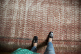 Distressed antique Persian Mir Serbend carpet with faded wine red boteh pattern and border.
