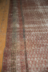 Distressed geometric border and faded boteh field of an antique Mir Serbend rug.