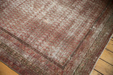 Distressed antique Mir Serbend carpet corner, featuring faded wine red field and ornate borders.