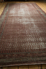 Distressed texture and time-softened tones of an antique Mir Serbend carpet border.