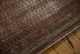 Distressed antique Mir Serbend carpet with repeating boteh motifs and time-softened burgundy and ivory tones.