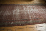 Antique distressed Mir Serbend carpet with textural pile, wine red, and light foundation.
