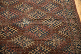 Geometric aubergine, navy, ivory hook gul motif and border section of antique Turkmen carpet.