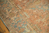 Distressed vintage Heriz geometric pattern with low pile in faded teal and dusty bronze.