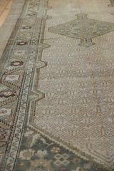 Angled detail of the vintage Serab rug's geometric field, worn texture, and slate blue border.