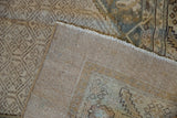 Hand-knotted construction and secured edge visible on the back of a distressed Persian rug.