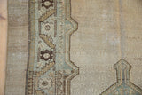 Detail of the distressed texture showing even wear to the knot heads and ivory field.