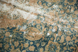 Visible foundation and soft teal, gold pictorial motifs on a distressed Kashmar carpet.