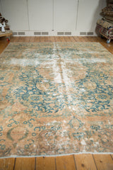 Worn texture and pictorial Rococo border of a vintage Kashmar rug with teal floral details.