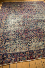 Worn vintage Yezd carpet border with scrolling vines in navy, cochineal, and ivory.