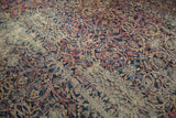 Elaborate scrolling vines in navy, cochineal, ivory on vintage Yezd rug, showing localized foundation wear.