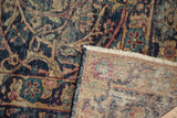 Vintage Yezd carpet pile with elaborate scrolling vines, visible hand-knotted foundation, and fringe.