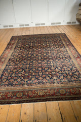 Vintage Fereghan Carpet's detailed red and ivory border, fringe, and traditional Herati motif.