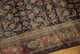 Finely woven vintage Fereghan carpet detail, navy Herati field meets black cherry red and ivory border.