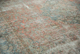 Distressed pale blush red and sky blue floral pattern with exposed foundation.
