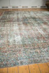 Distressed vintage Kashan carpet detail, with exposed foundation, knot heads, and pale blush red florals.