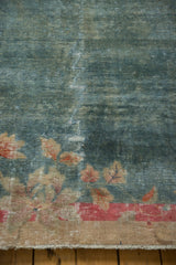Distressed Art Deco carpet lower edge with exposed foundation, faded red border, and floral designs.