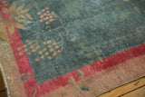 Distressed aqua field and red border on vintage Art Deco rug with floral motifs.