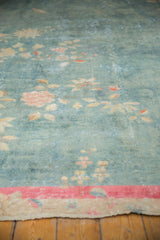 Distressed aqua Art Deco carpet with faded peach florals, visible foundation, and bright pink-red border.