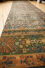 Forest green oversized border with terra cotta finned floral motifs on vintage Laristan rug.