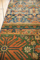 Finned floral contour and henna plant motifs on a vintage Laristan runner in blue, green, terra cotta.
