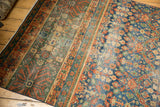 Vintage Laristan rug runner detail showing varied striped patterns, floral motifs, and foundation wear.
