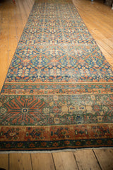 Vintage Laristan runner border with terra cotta finned floral contour and even wear.