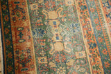 Vintage Laristan rug with green henna plant motif field and terracotta floral border.