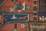 Aged low pile texture, stylized horse, and geometric patterns on antique Caucasian rug.