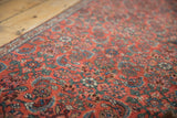 Textured low pile on a vintage Bijar rug with Herati motif in brick red, sky blue.