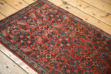 Traditional Persian Bijar runner, brick red field with sky blue, ivory Herati motif, narrow border.