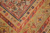 Distressed antique Persian Malayer rug, showing worn Herati motif in pale green, rust, and navy tones.