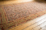 Decoratively distressed antique Malayer rug runner, faded Herati design in ivory and green.
