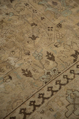 Distressed Tabriz rug detail: worn pile, faded ivory, powder blue lotus, dark pawn motif.