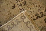 Distressed vintage Tabriz carpet corner with worn pile, exposed foundation, and pawn motif.