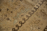 Vintage distressed Tabriz rug with bold pawn motif border and faded floral patterns.