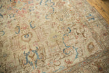 Distressed vintage Tabriz carpet with visible foundation and blue, terra cotta tendrils.