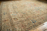 Textural low pile of a distressed Tabriz carpet, featuring softened blue and terra cotta patterns.