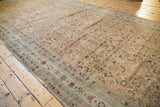 Textured distressed antique Malayer carpet with faded Herati motif in ivory and pale blue.