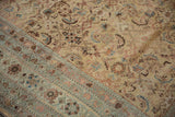 Distressed antique Malayer carpet detail: ivory Herati field meets pale sea foam border.