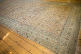 Antique distressed Malayer carpet corner with worn Herati pattern and pale sea foam borders.