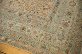 Distressed Malayer carpet corner with worn Herati pattern and soft pale blue border.