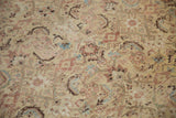 Distressed Malayer carpet displaying worn Herati motifs in pale ivory, blush, and powder blue.