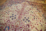 Antique Kermanshah carpet detail: mil fleur design, ivory field, visible foundation wear.