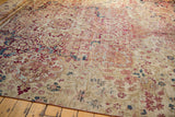 Antique Kermanshah carpet field with mil fleur design in muted red, ivory, and blue, showing pile wear.