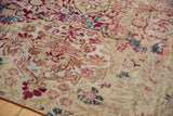 Antique Persian Kermanshah rug close-up: mil fleur pattern with pile wear, cochineal red, ivory.