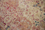 Worn mil fleur pattern in cochineal red, ivory, and sky blue on antique Kermanshah carpet.