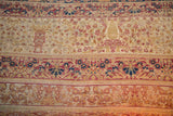Antique Kermanshah carpet: mil fleur field, intricate red, blue, ivory borders, with visible wear.