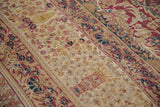 Hand-knotted antique Kermanshah carpet's mil fleur field in cochineal red, navy, and ivory.