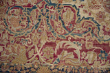 Antique Kermanshah rug: intricate mil fleur pattern with jewel tones and visible pile wear.